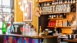 A vibrant eatery with a colorful counter labeled "EATARTRUCK" and a menu for American BBQ. - Darlo Bar Darlinghurst (Darlinghurst)
