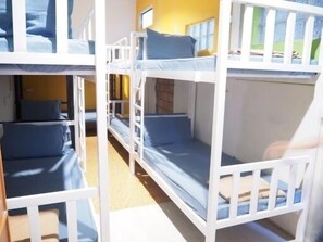 A bunk bed room with two beds, each with blue bedding.