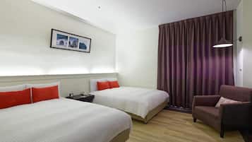 A hotel room with two beds, a chair, a nightstand, and a picture on the wall.