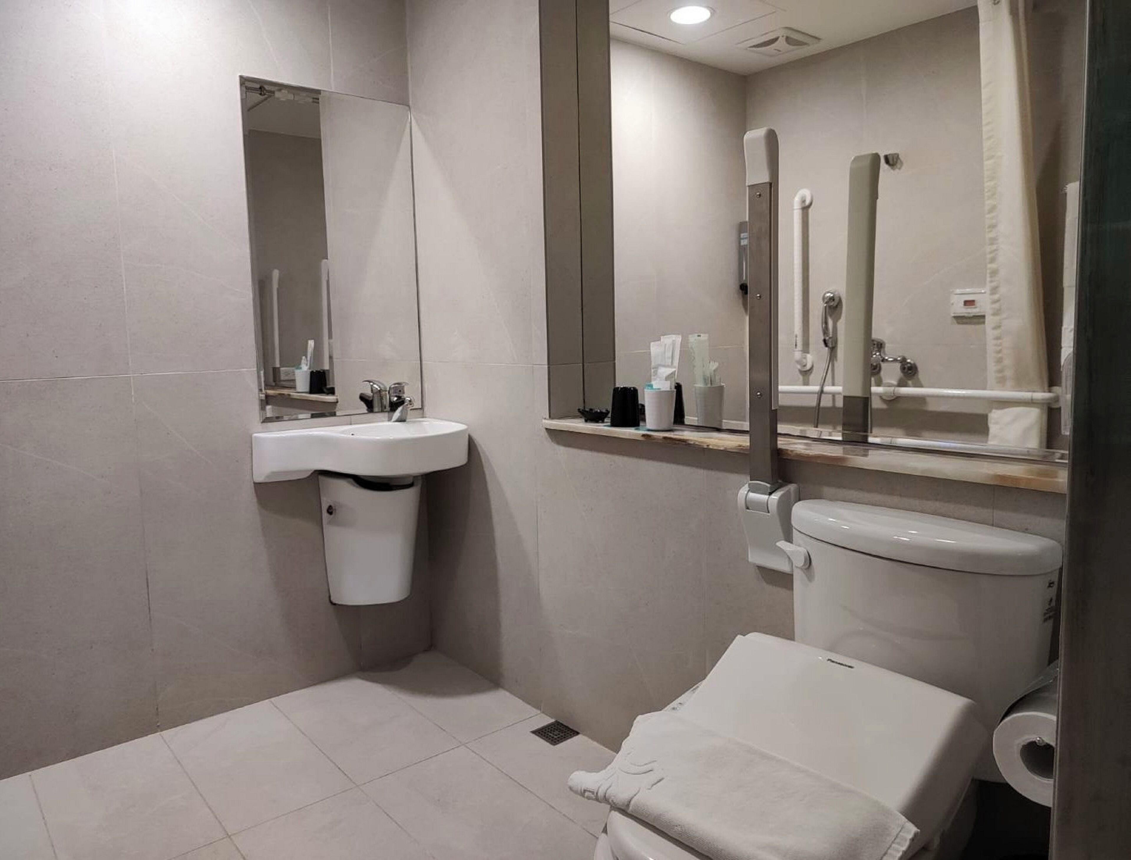 superior accessible room - no window no parking | bathroom | shower, rainfall showerhead, hair dryer, slippers