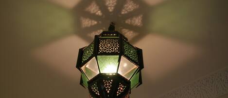 A traditional lantern with intricate patterns and a central light source.