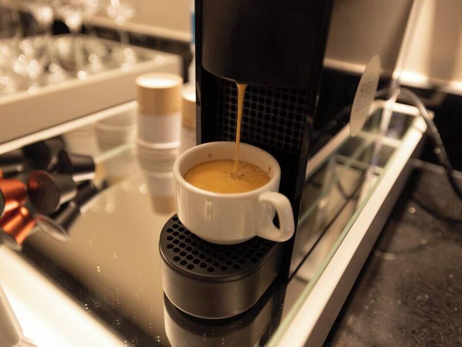 A coffee machine dispensing coffee into a cup.