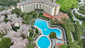 A large hotel with multiple swimming pools, lush greenery, and a well-maintained landscape. - Miramare Queen Hotel - All Inclusive (Manavgat)