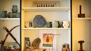 A display of pottery and decorative items on shelves. - Harwood Hill Motel (Bennington)