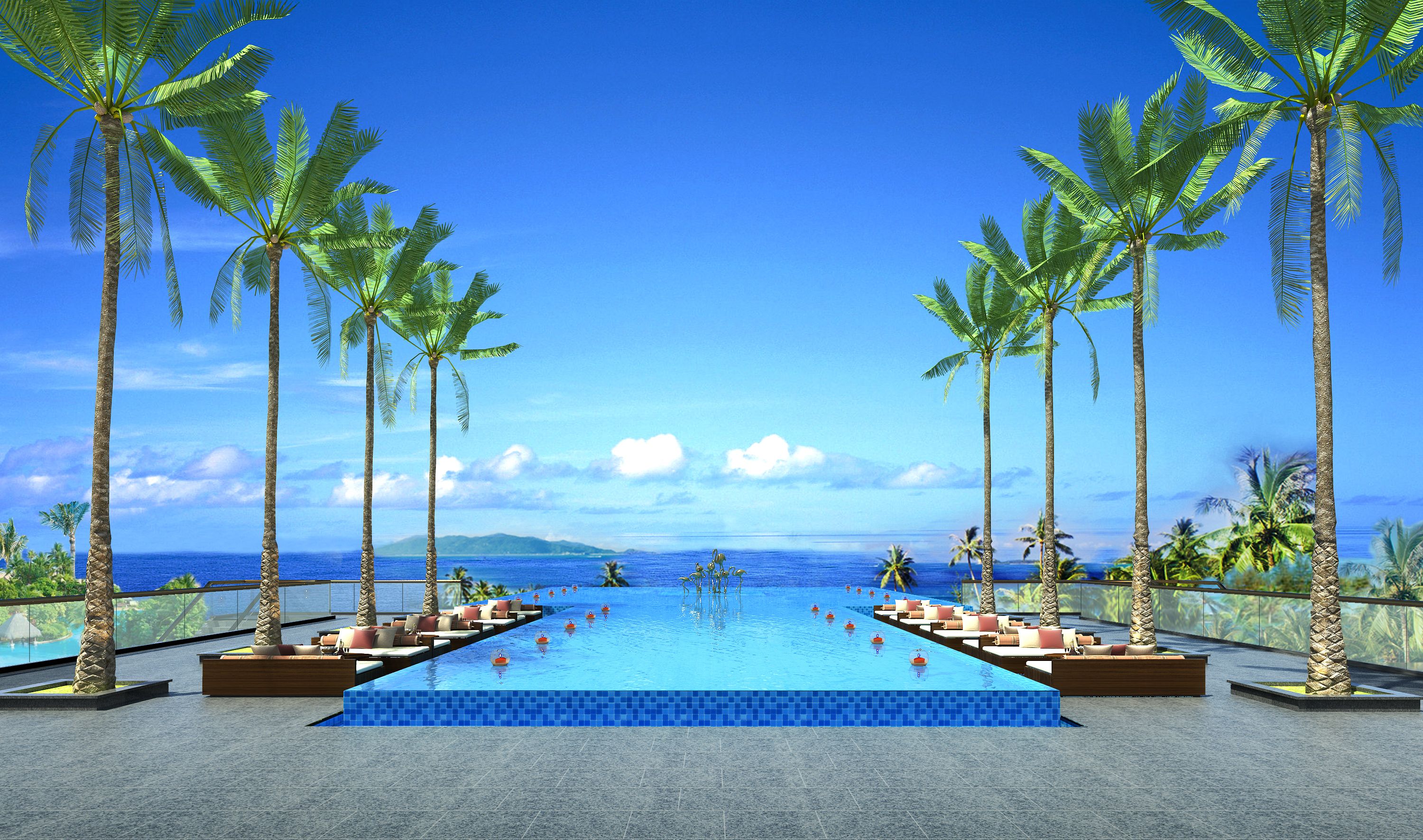 A pool with a view of the ocean, surrounded by palm trees and lounge chairs.