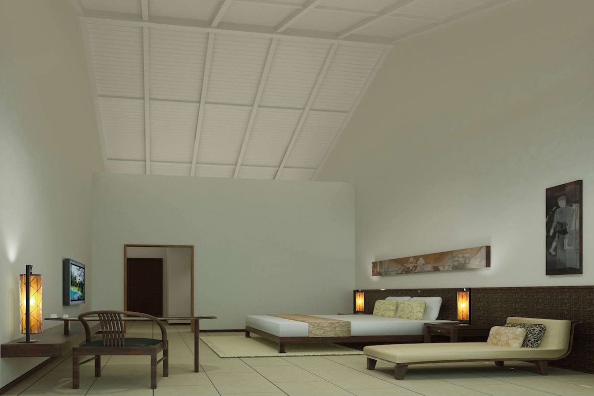 A modern hotel room with a large bed, a sofa, a chair, and a desk. There is a painting on the wall and a door leading to another room.