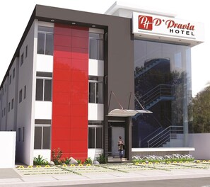 Experience the contemporary design of P+P'Dravida Hotel, featuring a clean facade and a beautiful garden area.