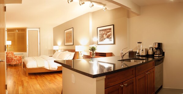 A modern kitchen with a central island, wooden cabinets, and stainless steel appliances.