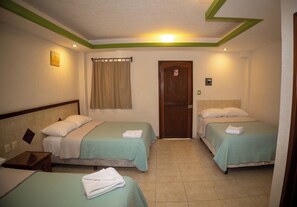 A hotel room with two beds, a door, and a window with curtains. - Nicte Ha Campeche (Campeche)