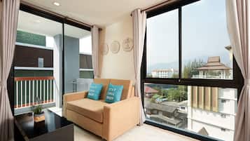 One Bedroom Suite | Living area | 32-inch LCD TV with cable channels, TV