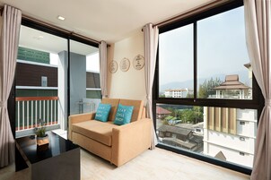 One Bedroom Suite | Living area | 32-inch LCD TV with cable channels, TV