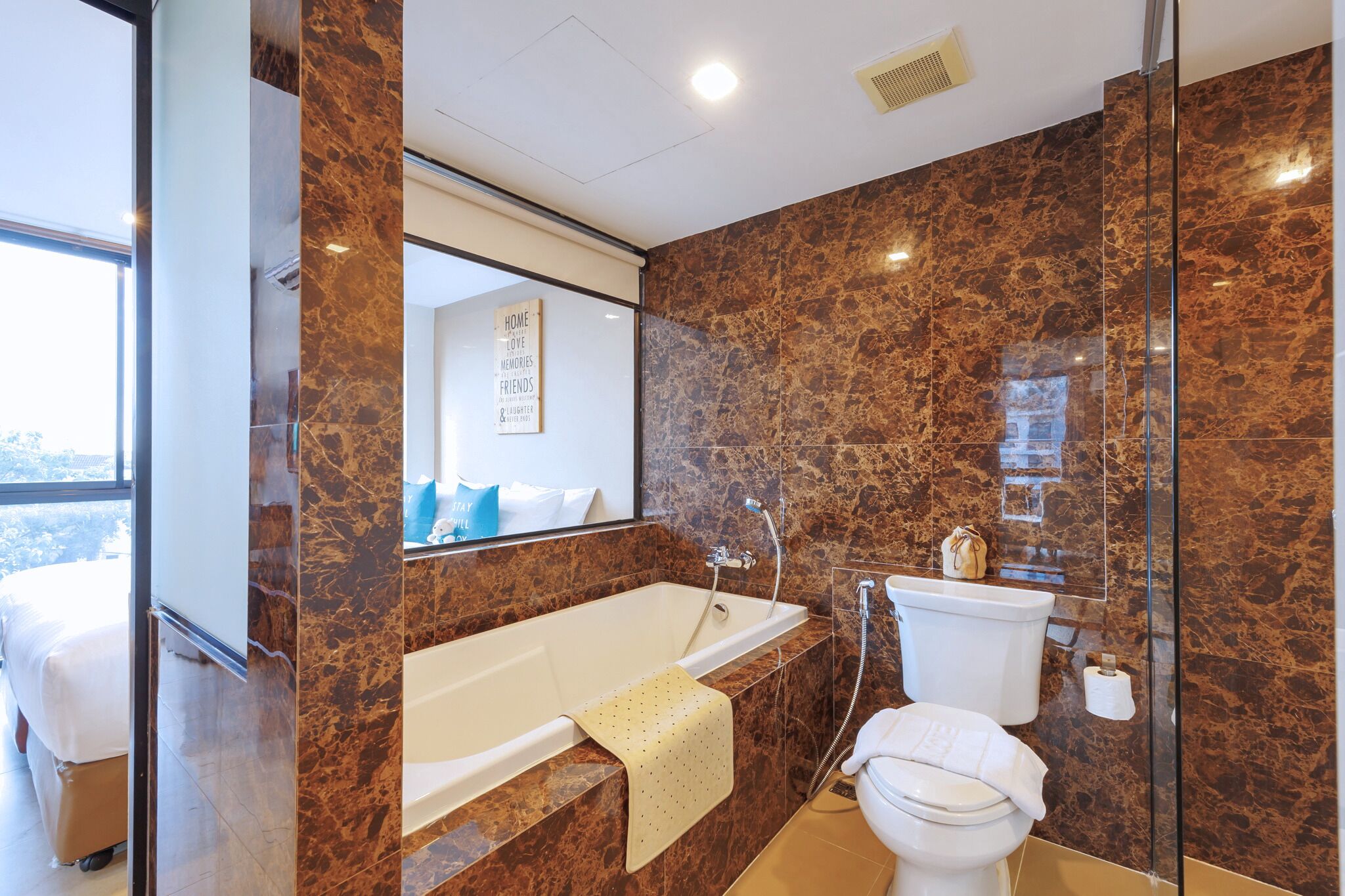 A modern bathroom with a bathtub, toilet, and shower.