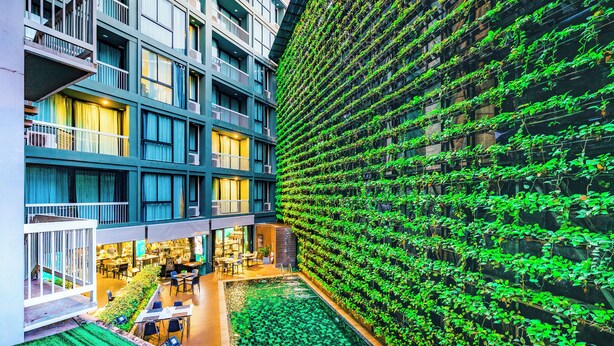 A modern building with a rooftop garden and a large vertical garden wall. - Cross Vibe Chiang Mai Decem (Chiang Mai)