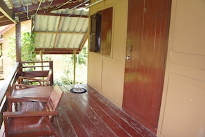 A wooden bench and a door with a number "3" on a building's exterior wall. - Vang Vieng Eco Lodge (Vang Vieng)