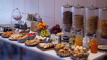 A buffet with various food items and beverages.