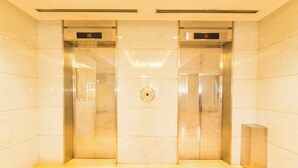 A modern elevator with a digital display showing the floor number.