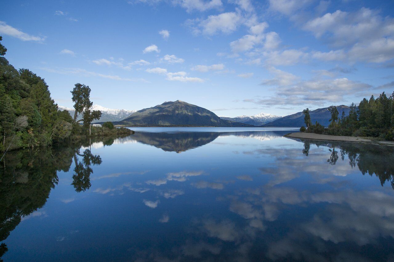 A tranquil lake with a mountain in the background.