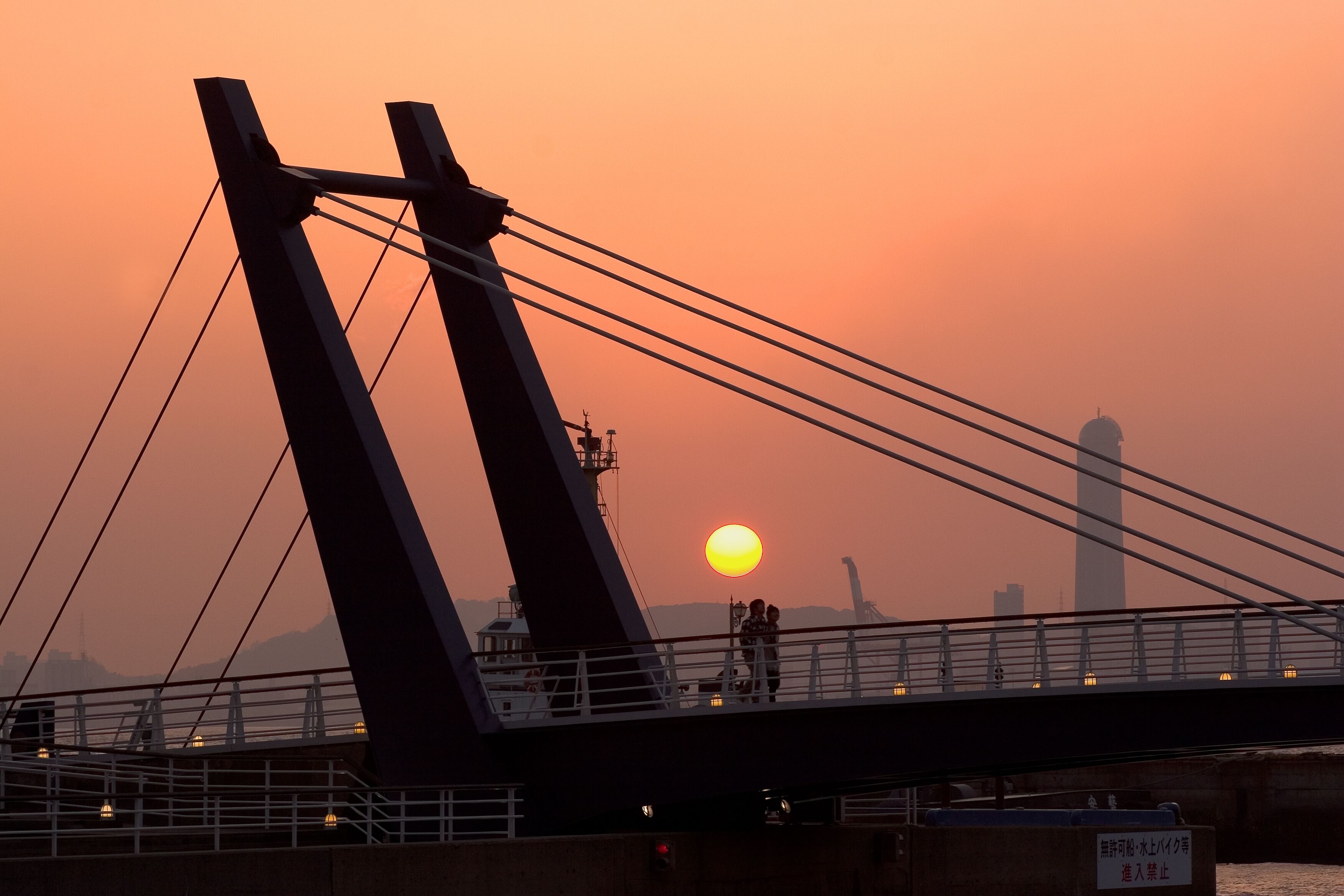 A bridge with a sunset in the background.