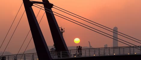 A bridge with a sunset in the background.