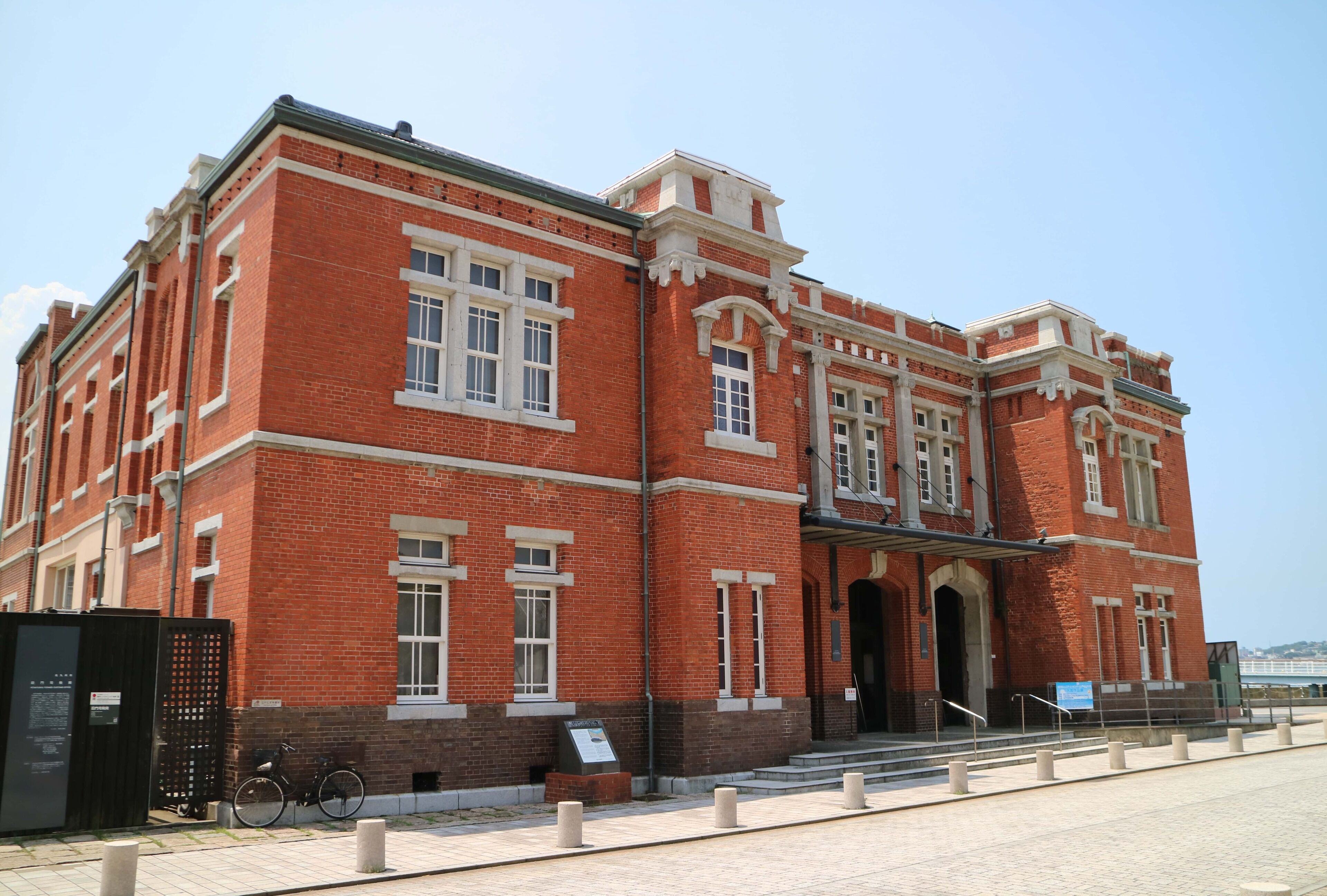A large brick building with multiple windows and a central entrance.