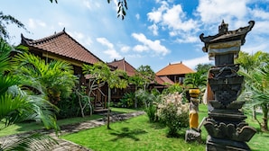 A traditional building with a tiled roof, surrounded by lush greenery and a stone pathway. - The Cozy Villas Lembongan by ABM (Lembongan Island)