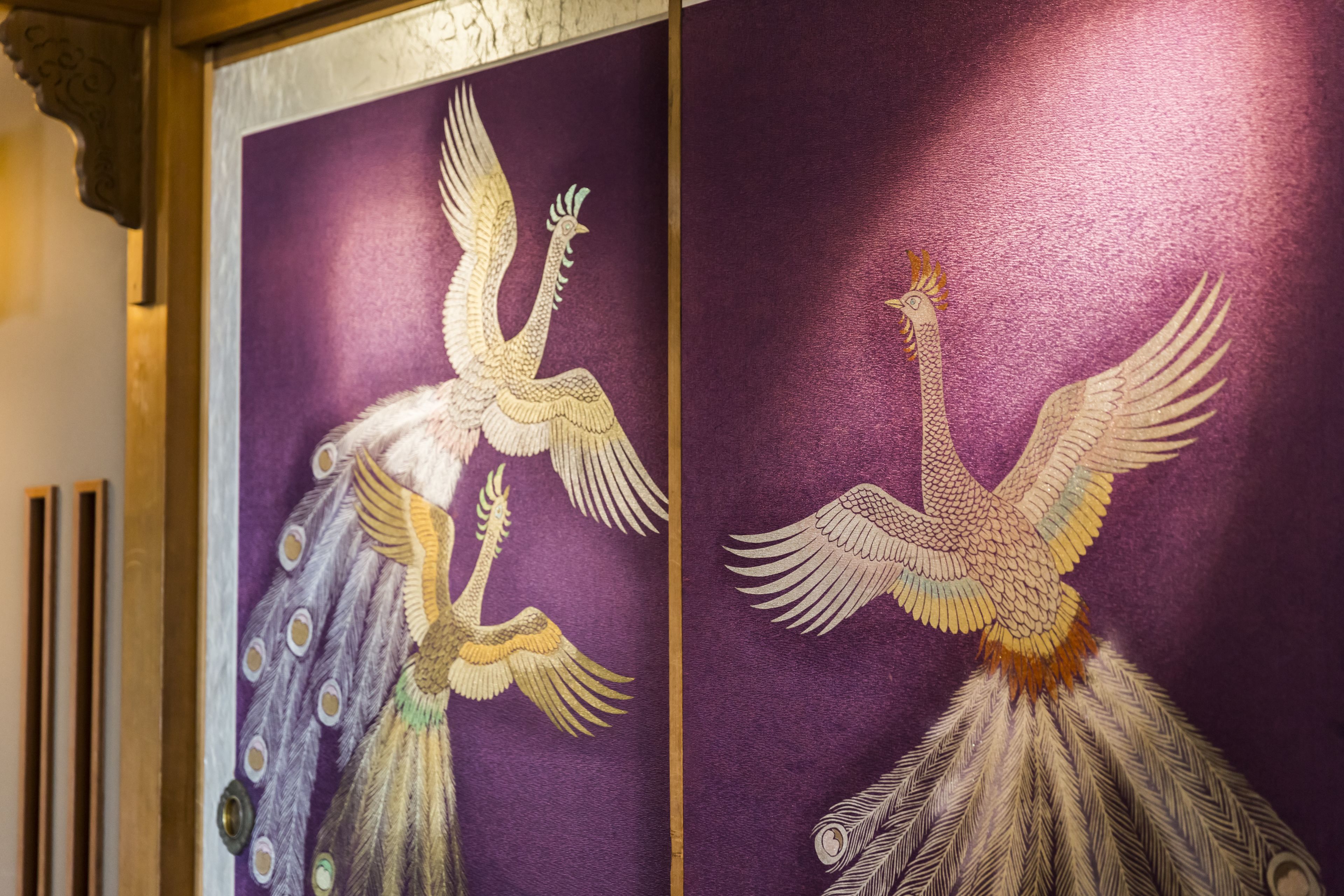 Two ornately decorated panels with peacock designs.