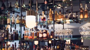 A bar with shelves of liquor bottles and glasses. - Morgan and Mees Amsterdam (Amsterdam)