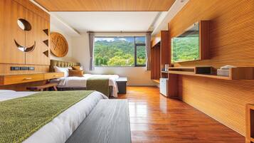 A modern bedroom with a large bed, a smaller bed, wooden walls, a large window with a mountain view, and a wooden wardrobe.