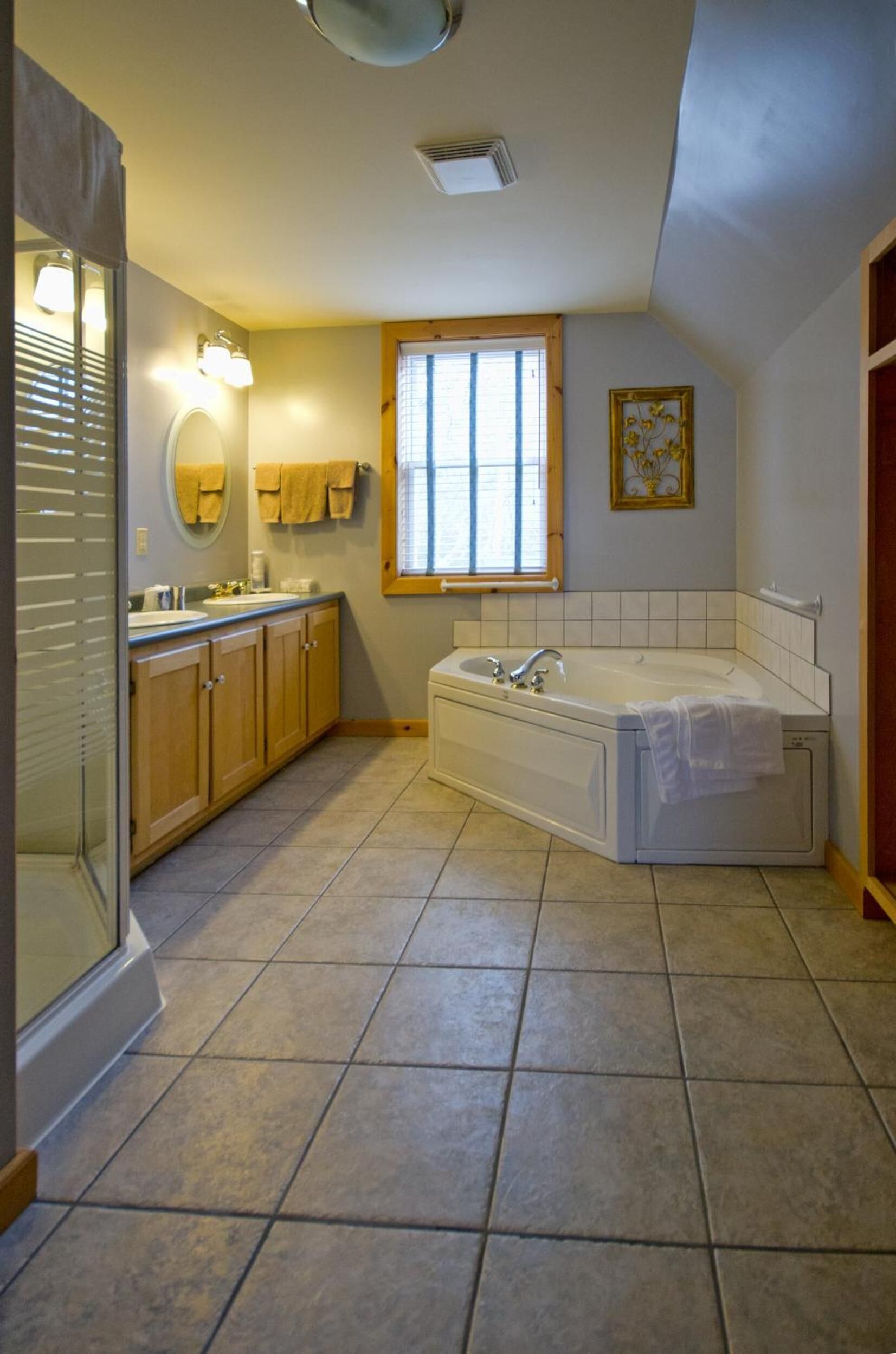 A bathroom with a bathtub, a sink, and a vanity.