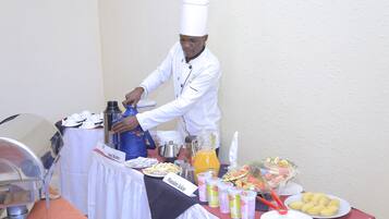 A buffet setup with various food items and beverages.
