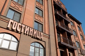Experience the charm of Fostinka, a building with a unique brick facade and decorative geometric patterns.