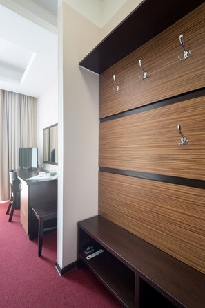 Relax in a stylish room with a flat-screen TV, desk, and comfortable chair.