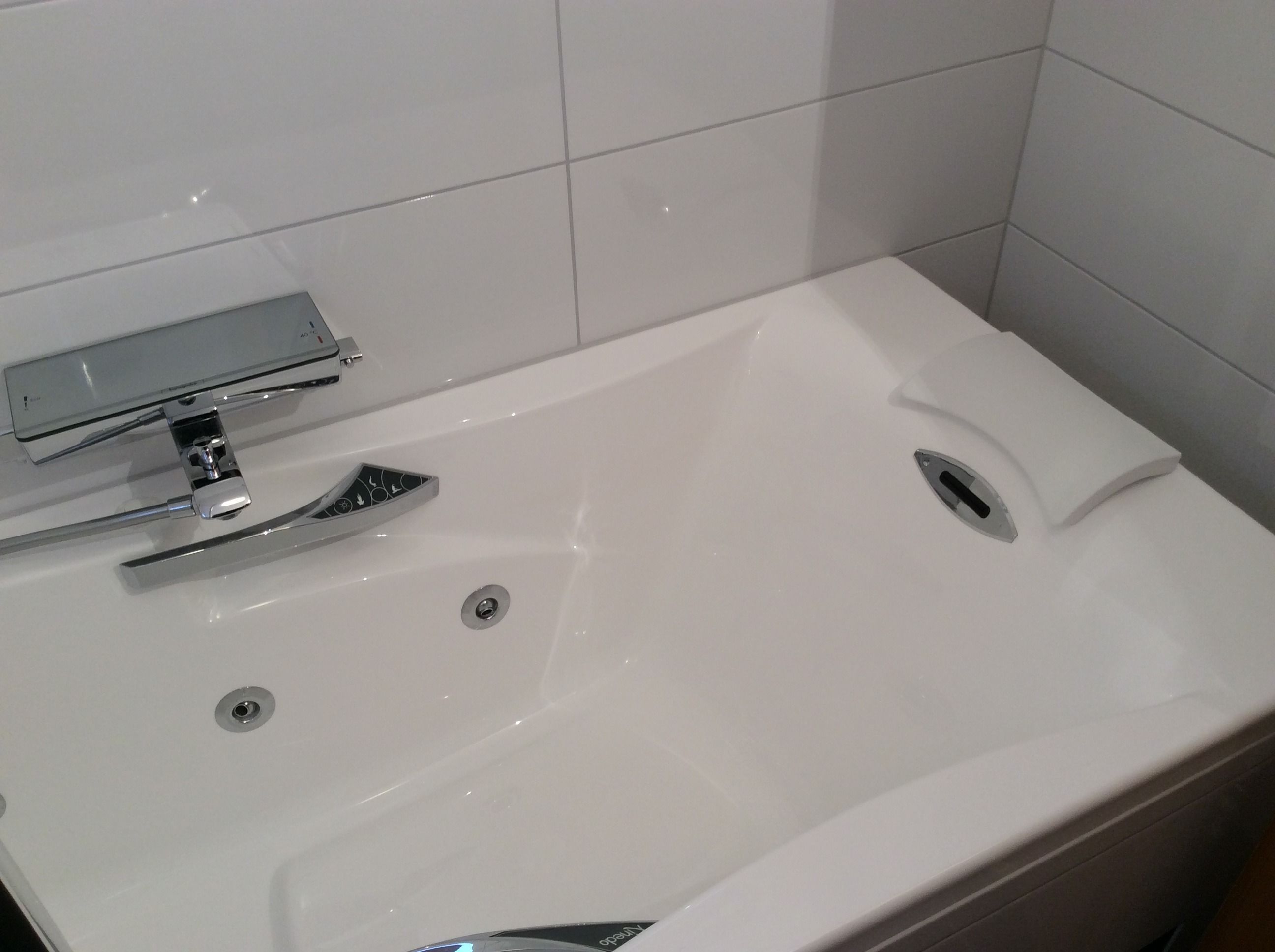 A white bathroom sink with chrome fixtures, a mirror, and a towel rack.
