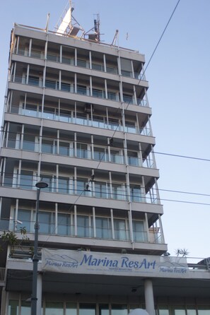 A multi-story building with a banner advertising "Marina ResArt." - Marina ResArt B&B (Naples)
