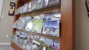 A display of travel brochures on shelves. - Cornerstone Bed and Breakfast (Revelstoke)