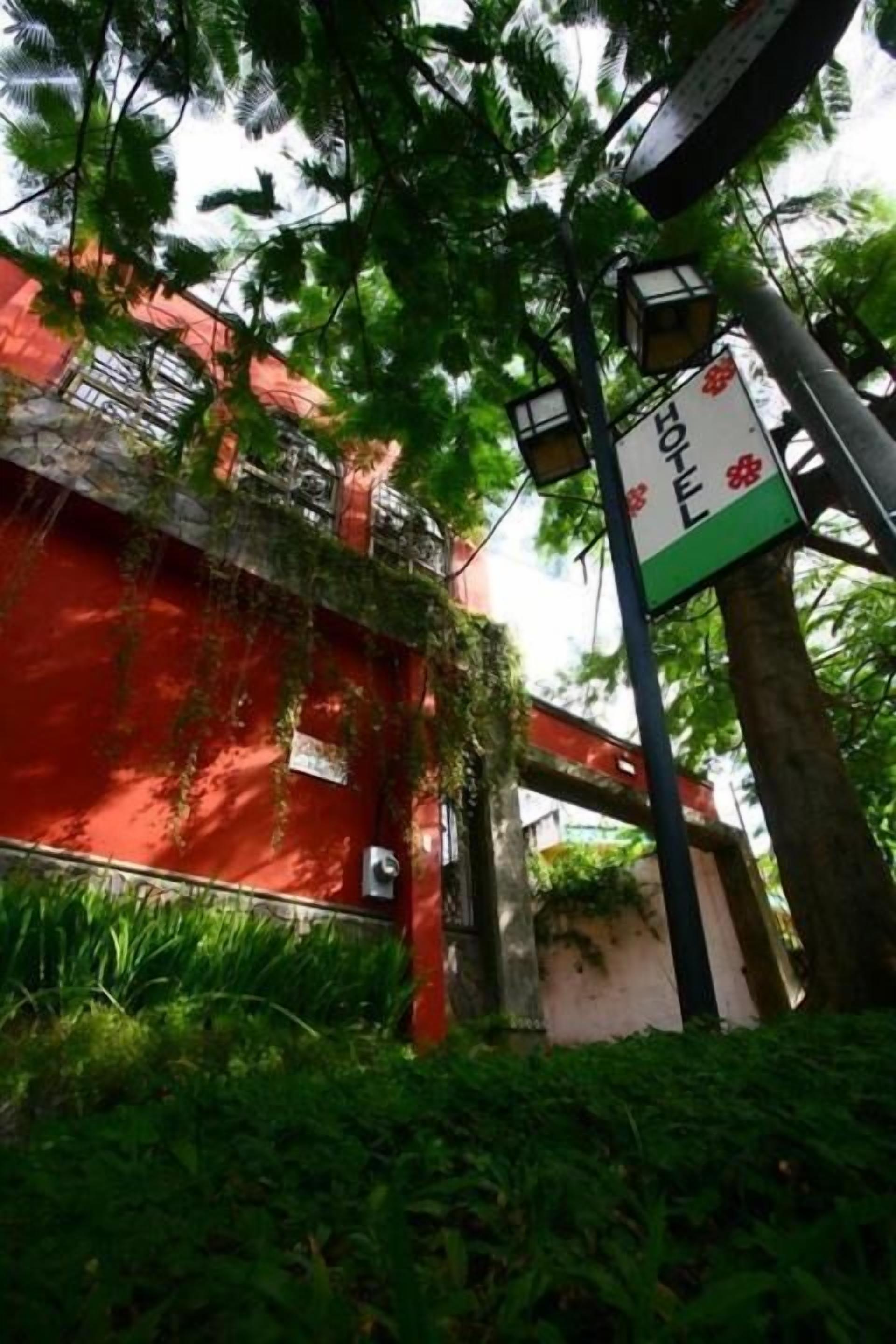 A red building with a sign indicating a hotel.