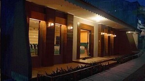 A building with a covered porch and multiple doors, likely a hotel or guesthouse. - Patria Garden Hotel (Blitar)