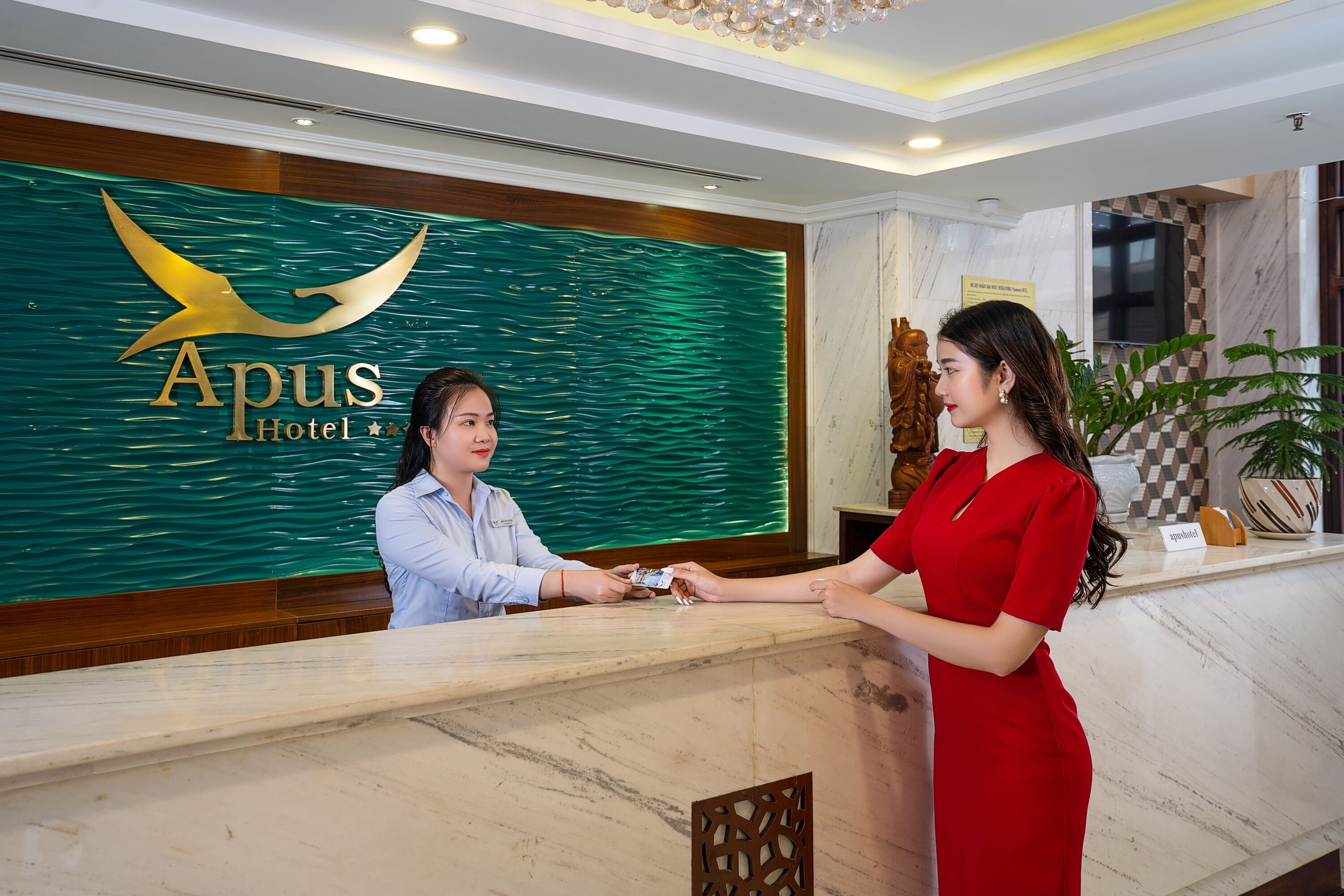 Un mostrador de recepción de hotel con un logotipo y una placa de identificación.