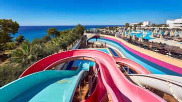 A water park with multiple slides and a pool area.