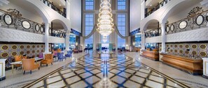 A spacious lobby with a grand chandelier, multiple seating areas, and a check-in counter. - Litore Resort Hotel & Spa - All Inclusive (Alanya)