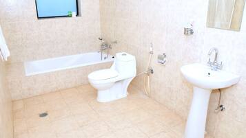 A bathroom with a bathtub, toilet, and sink.