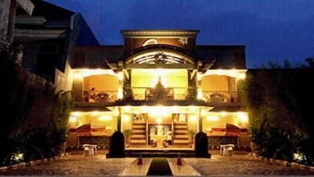 A two-story building with a central entrance, large windows, and a symmetrical facade. - Patria Palace Hotel (Blitar)