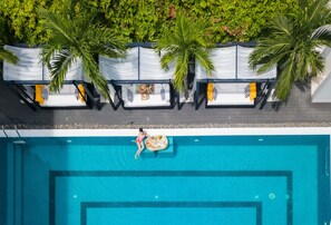 An aerial view of a swimming pool with lounge chairs and palm trees. - Hoian Sincerity Hotel & Spa (Da Nang)