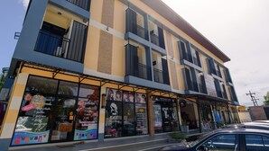 A multi-story building with large windows and balconies. - Petch Ranong at Town (Ranong)