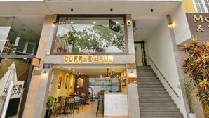 A multi-story hotel with a coffee shop at the ground level. - Dreams Hotel Danang (Da Nang)