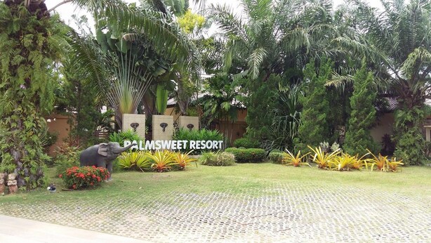 A sign for PalmSweeet Resort surrounded by lush greenery and a decorative elephant statue. - Palm Sweet Resort (Chumphon)