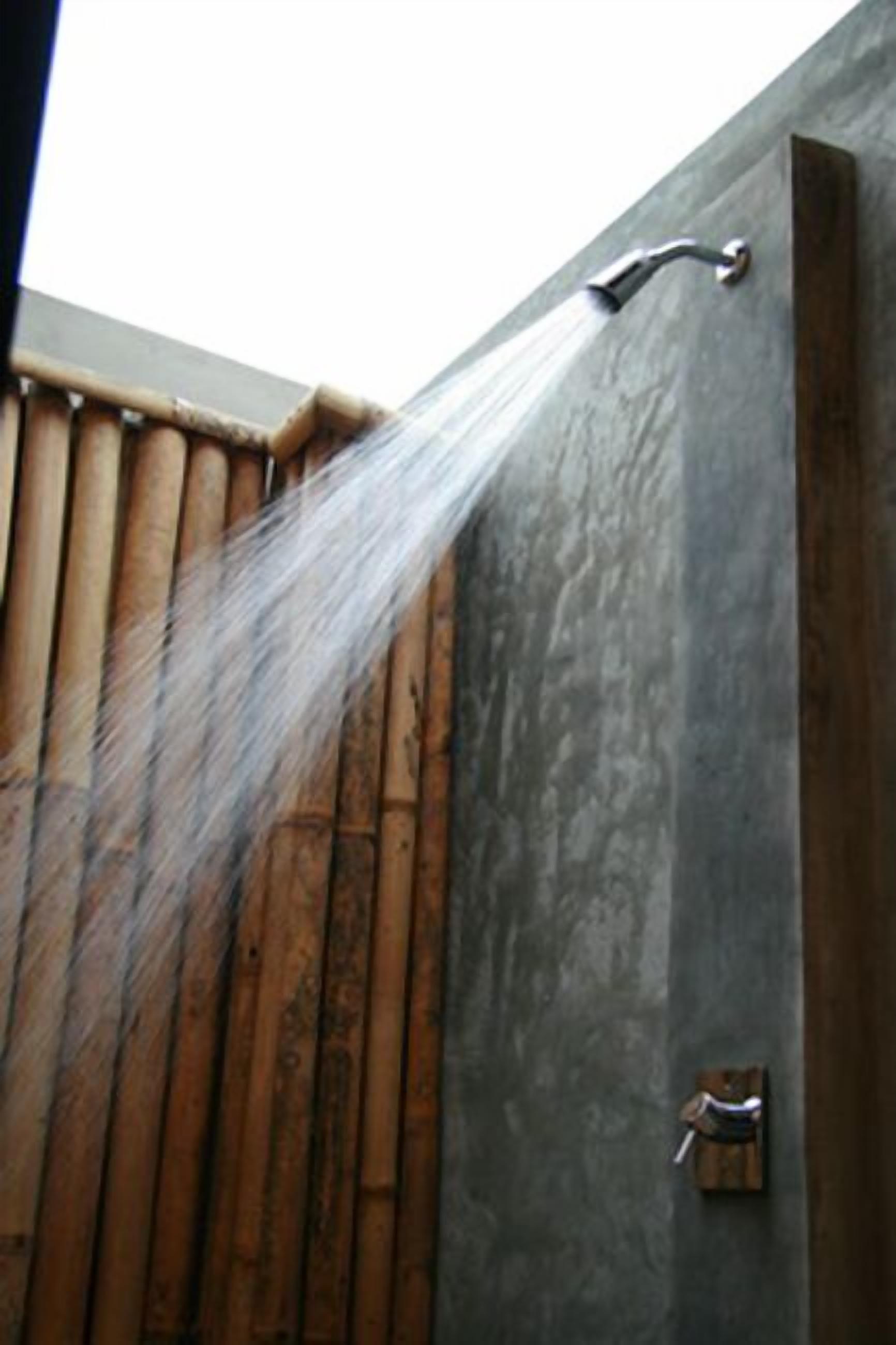 A shower with water spraying down a wall.
