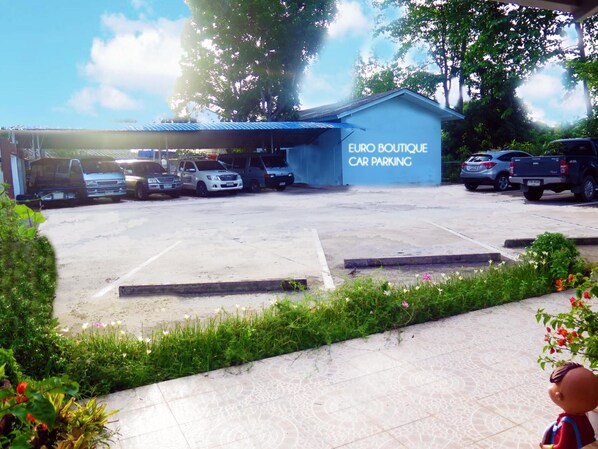 A car parking area with a sign that reads "EURO BOUTIQUE CAR PARKING". - Euro Boutique Hotel (Chumphon)