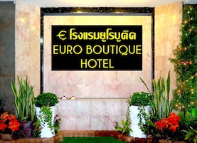Señal del Euro Boutique Hotel, con pared de mármol y plantas en macetas.