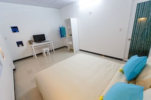 A bedroom with a bed, a desk, and a wardrobe. - Retreat Home Hoian (Da Nang)